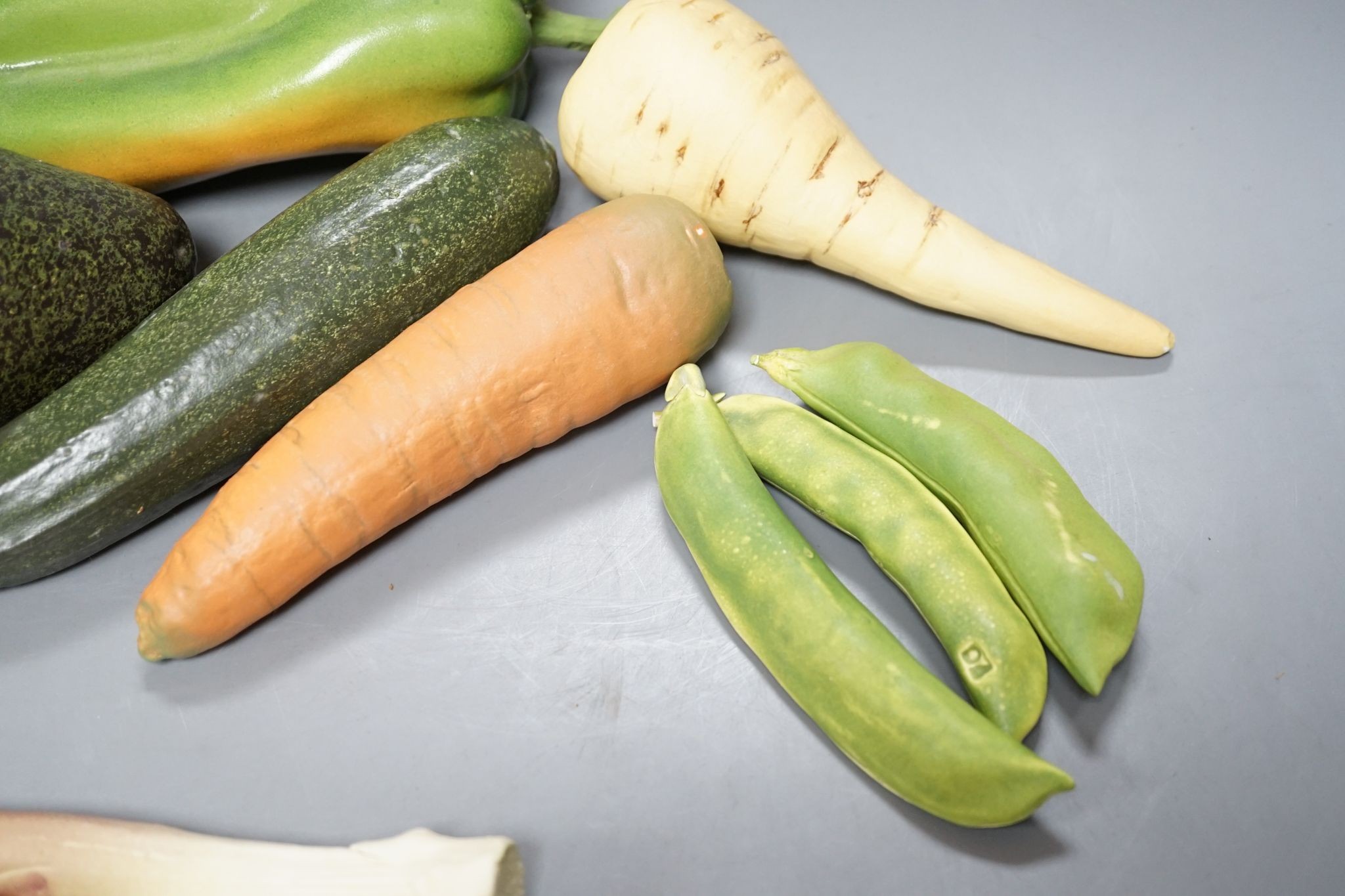 A collection of vintage Penkridge ceramic vegetables including an artichoke, avocado, peppers and asparagus (19 items)